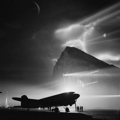 Douglas DC-3 of BOAC at Gibraltar, silhouetted by searchlights on the Rock